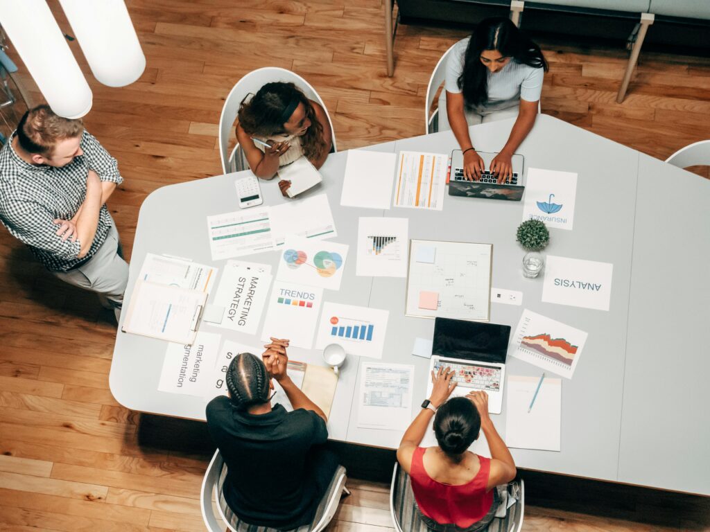 Image showing a diverse team collaborating on SEO strategies, analyzing website content, keyword research, and search engine rankings to improve nonprofit online visibility and search results.